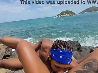 Tattooed Brazilian babe goes bareback on nudist beach rock