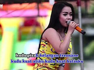 indonesian singers doing wild erotic dance on stage with eager crowd